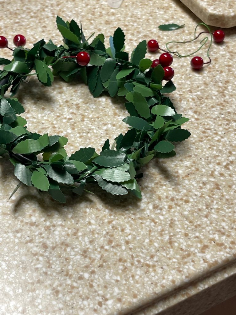 Removing red berries from the wreath