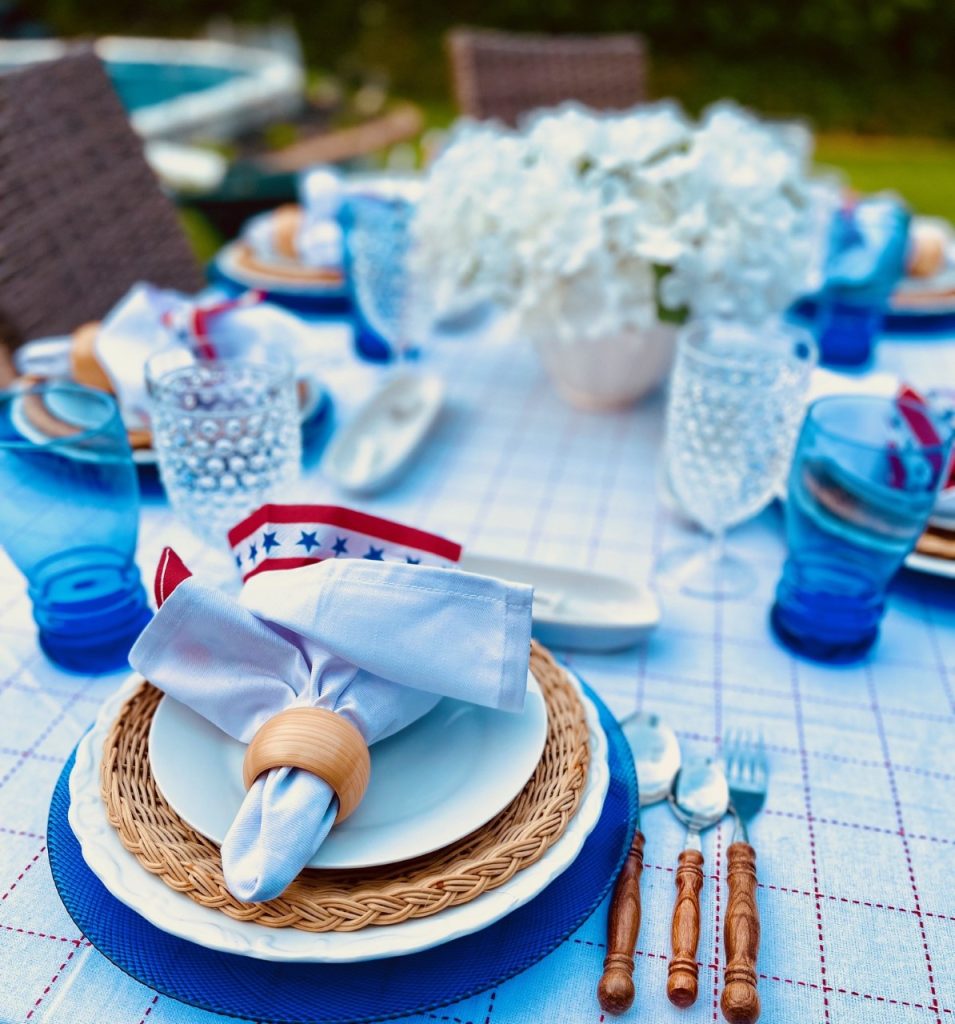 Adding a blue charger to the table setting