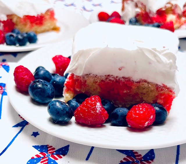 Finished recipe of gluten free raspberry poke cake with whipped frosting 