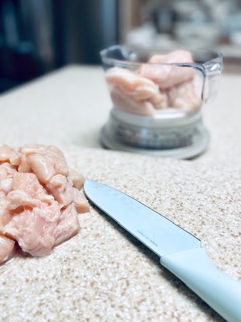 Dicing Chicken on a cutting board
