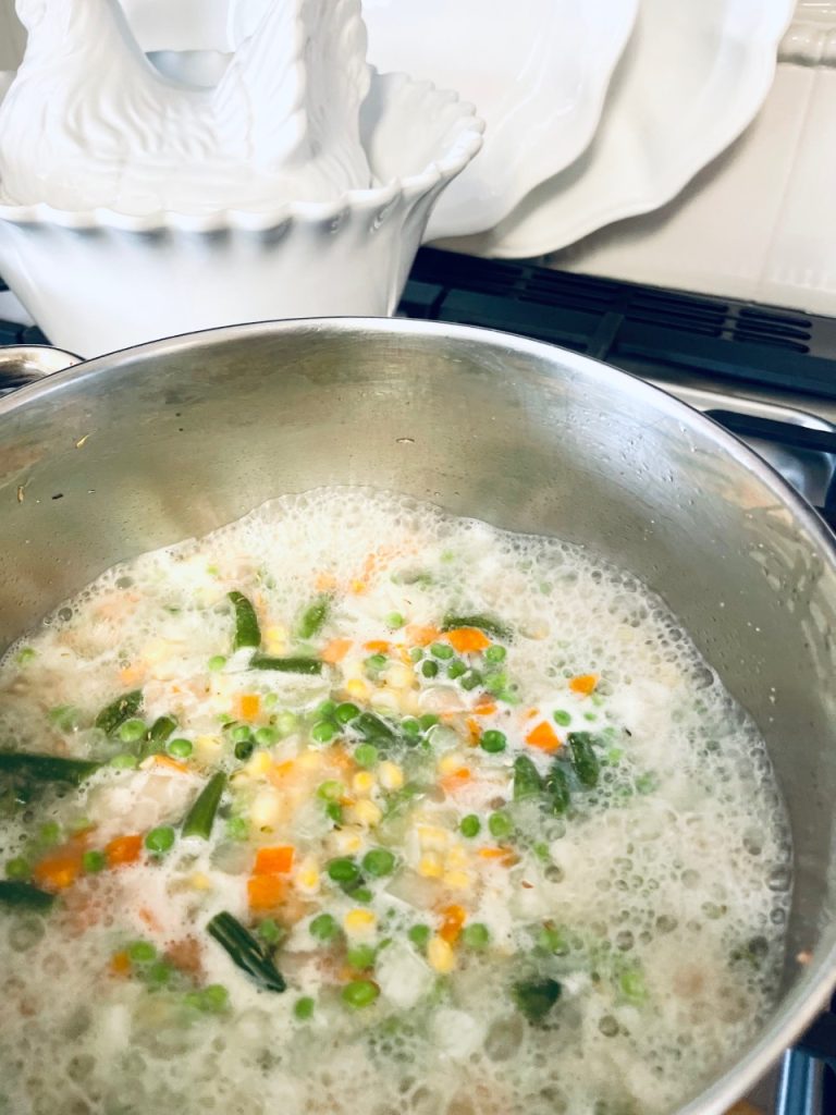 Vegetables and chicken mixture coming to a boil