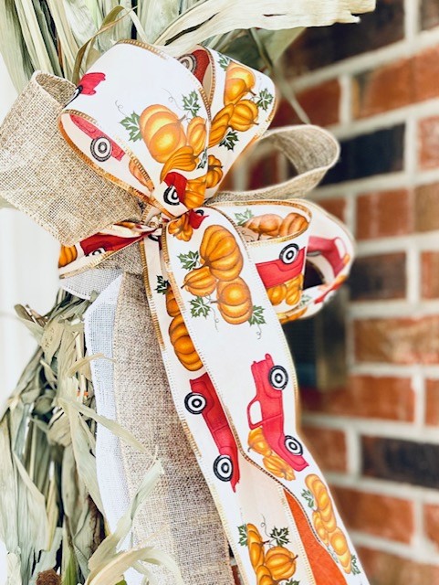 Creating a bow for the porch with fall ribbon