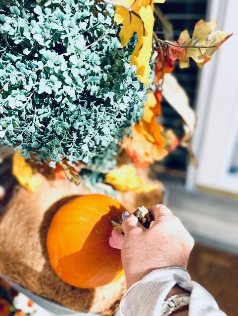 Adding a pumpkin to the porch