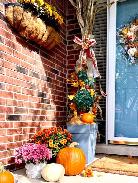 More pictures of the porch with pumpkins and mums with corn stalks and ribbon