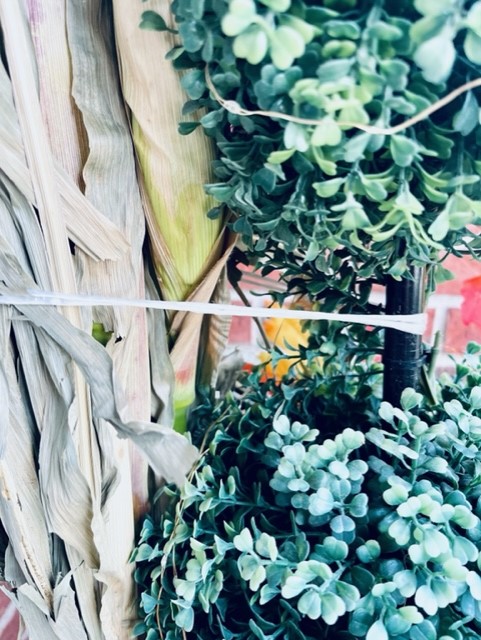 How I tied the corn husk to the topiary on the porch 